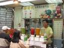 A fresh juice stand.  I had a fresh kiwi juice, which was good.  I knew it
was fresh because, besides being in a blender, I could see seeds and taste
the pulp.  Di Yin, waking up one morning a month later, looked at my
screen to see what I was viewing, saw this picture, and thought it was
taken in Singapore. :)
