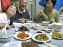 Di Yin and her parents, along with our bowls of brisket soup with rice
noodles.  The broth, which was actually chicken soup, was good.  The
plates arranged in front of us are (clockwise) some kind of pasta (?),
jellyfish, fish sausage, tofu and bok choy stir-fry, shrimp in
ketchup/tomato sauce, and the usual sweetened tofu and wood ear mushrooms.  
The last was homemade.  The unknowns are because I didn't try everything
and don't recall what they were.
