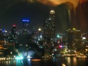 A picture focused on the buildings just across the river.
