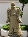 This old guy (statue) seems very happy with his fruit (a guava?).
