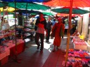 Outside the Grand Palace, a monk in the street markets of Bangkok.
