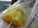 Street-side bought fresh pineapple.  The vendor held the pineapple
in his hand as he cut it!  He must really know how sharp his knife is and
how resistant the fruit is lest his knife go too far and cut himself.  As
I noticed over the course of my trip, this method of cutting fruit is a
common (though stupid) practice in Bangkok.

