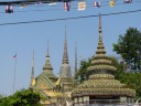 Lines of elaborately detailed towers (stupas) by the Temple of the
Reclining Buddha (Wat Po). Would be excellent if I cropped out the 
flags and power lines.
