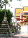 A row of stupas in front of a different hall.
