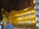 A feet-to-head picture of the reclining Buddha.   The Buddha is made 
from brick that was then covered with plaster and finally with gold leaf.
