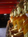 Another row of Buddhas, elsewhere, this set clothed.
