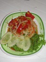 Som tam (a.k.a. papaya salad).  When I ordered this, I showed the
woman my chowhound passport, a card that said in Thai "Please bring me the
serious, authentic food . . . not the tourist stuff." She gave me a funny
look like she was confused and didn't understand and called another women
over.  The other woman read the card, nodded, and said something to the
first.  One asked me (in English) whether I wanted it normally spicy (or
something that I took to mean that).  I said yes.  She then shows me a
palm-full of chilies.  I blanch.  They laugh.  I make a motion for them to
give me half that much.  This was good and fairly spicy, yet I've
had spicier papaya salads before so I probably could've handled a bit more
(though undoubtedly not twice as many chilies).
