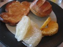 My final plate of food.  (Gosh I ate a lot!)  Toast with butter, roll 
with butter, pineapple, and pomelo.

