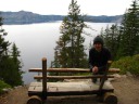 Yours truly on a rustic bench in front of Crater Lake.  We didn't stop 
and sit here because we were excited to hike this trail down to the 
lake.

