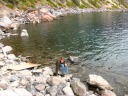 At the bottom, I clambered over these rocks to put my finger in the 
lake.  

I have a lot of pictures of myself climbing over the rocks but I won't 
bother to upload them.


Also note the turquoise water at the right-center.
