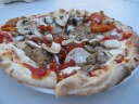 Our "diavola" pizza, with sausage, mushrooms, and sun-dried tomatoes.
