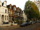 Further down the street, my apartment is in the second house on the left 
(the first brown one). It has a metal gate.  I took this picture 
on November 10, 2010.
