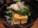 "Deep-fried tofu topped with fresh winter herbs" that turned out to be 
watercress and radish.  The shredded white stuff is grated horseradish.  
The tofu was softly fried.
