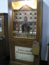 Watching people get killed was another common mechanical motion display.  
In this machine, English Execution, the doors open and one sees a man 
kneeling before a priest and then getting his head chopped off.

