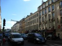 This large street in the town of Versailles has many buildings with 
shutters.  Also, I think the flags hanging above the road are a nice 
touch.
