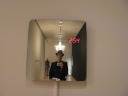 Self-portrait using mirror with an embedded clock.
