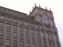 The decorative top of the Warner Theater building.
