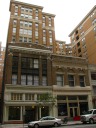 At left, the entrance to our apartment building.  The apartments 
themselves are in the taller buildings with pale brown stones set 
back from the street a bit.  Our window isn't visible; we're on the 
other side of the building.
