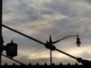 The sky, a lamp-post, an awning, and a clock, as seen looking west near 
sunset from 7th and F NW, about three blocks from our apartment.
