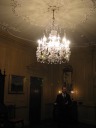 The poor quality of this picture makes a poor introduction to the rooms, 
but it's the first picture I shot and shows the Entrance Hall.  Hence, 
I'm putting it first.  It shows ceiling flourishes, a British crystal 
chandelier, antique furniture, and paintings.
