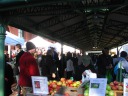 Outdoor farmers market stands are under this long pavilion roof.
