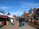 An uncovered section of the market: restaurants in the buildings on the 
right; artsy stuff in the booths on the left.  The previously 
photographed covered part of the market is the next row to the left.
