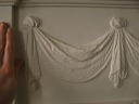 The fireplaces' mantels have detailed carvings.  Notice how fine are the 
dots that give this carving the impression of flowing cloth.
