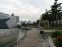 Looking along Marina Bay Sands waterfront boardwalk toward the 
ArtScience Museum.  It's a pleasant place to stroll.


The two glass buildings at left (one in foreground and one in the 
distance) that spring out of the water are the so-called Crystal 
Pavilions.  They'll house shops and clubs.  I think they'll be a neat 
venue.  They'll be accessible by this boardwalk and by an underwater 
tunnel.
