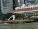 A wider angle shot of the merlion with the historic Fullerton Hotel in 
the background.
