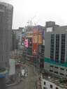 A few days later, the hotel cleaned the building's windows.  Hurrah!  
This is the view from our room toward Dundas Square.  Note the streetcar 
lines and massive billboards.  This picture was taken on March 16, 
2012.
