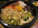 My dulsot bibimbap, mixed vegetables with rice in a stone pot.  (Di Yin 
and I each ordered large combination meals because we were both hungry.)  
It's the usual bibimbap ingredients.  Unlike with the previous bibimbap, I was 
smarter and didn't mix the rice into the bibimbap.  This was I could 
balance the rice and veggies on my own as I ate.  Also, this time I 
found no need for chili sauce; there was enough stuff going on with the 
vegetables.  In short, I thought this food was better.

By the way, the brown stuff in the upper-right of the pot is pickled 
bamboo.  Di Yin said it was delicious.
