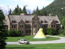 A view from the gardens down towards Canada place.  The whole view seems
very Canadian: the flag, a relic representing history (a teepee in this
case), the Colonial house, evergreens everywhere,
and snow-topped mountains in the distance.
